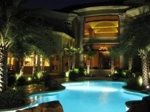 large home with pool and landscaping and lighting